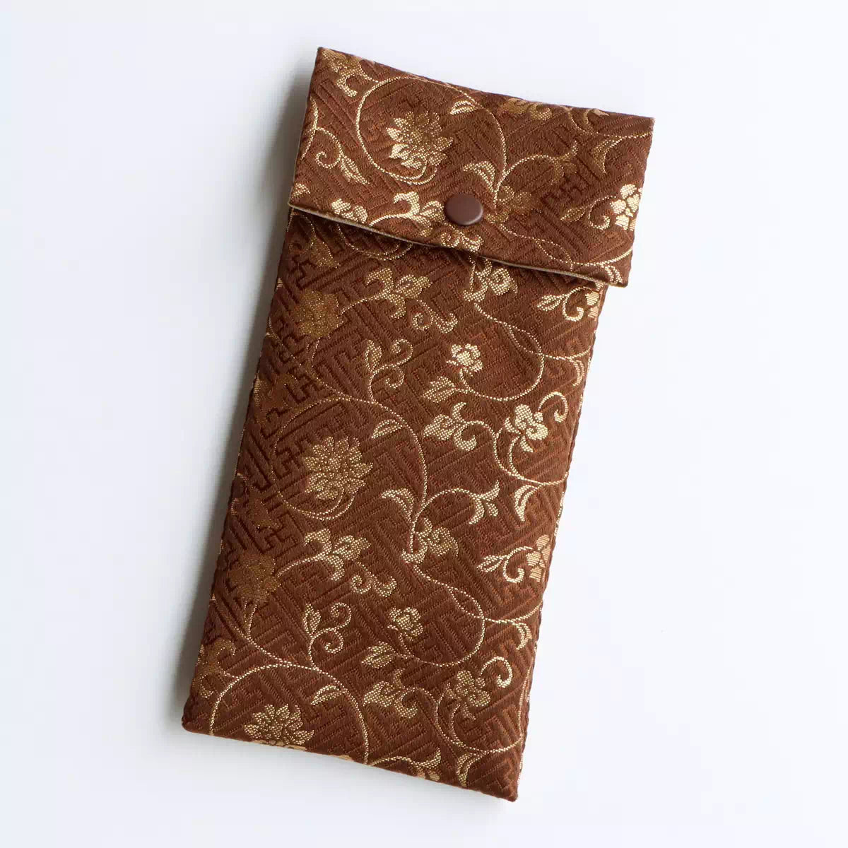 茶。紗綾型に花唐草を重ね金色の文様が静かにきらめきます。